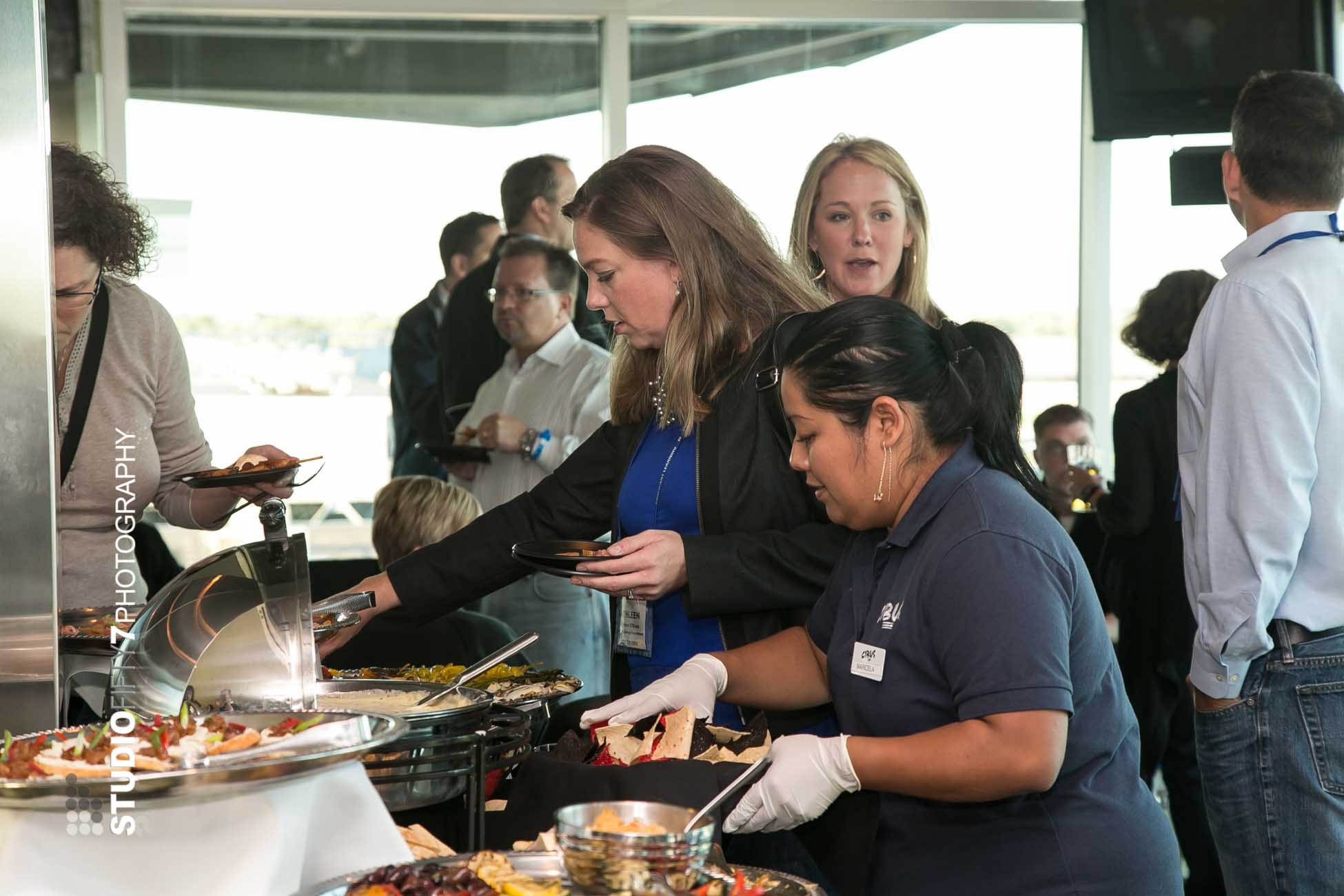 People enjoying catered event buffet