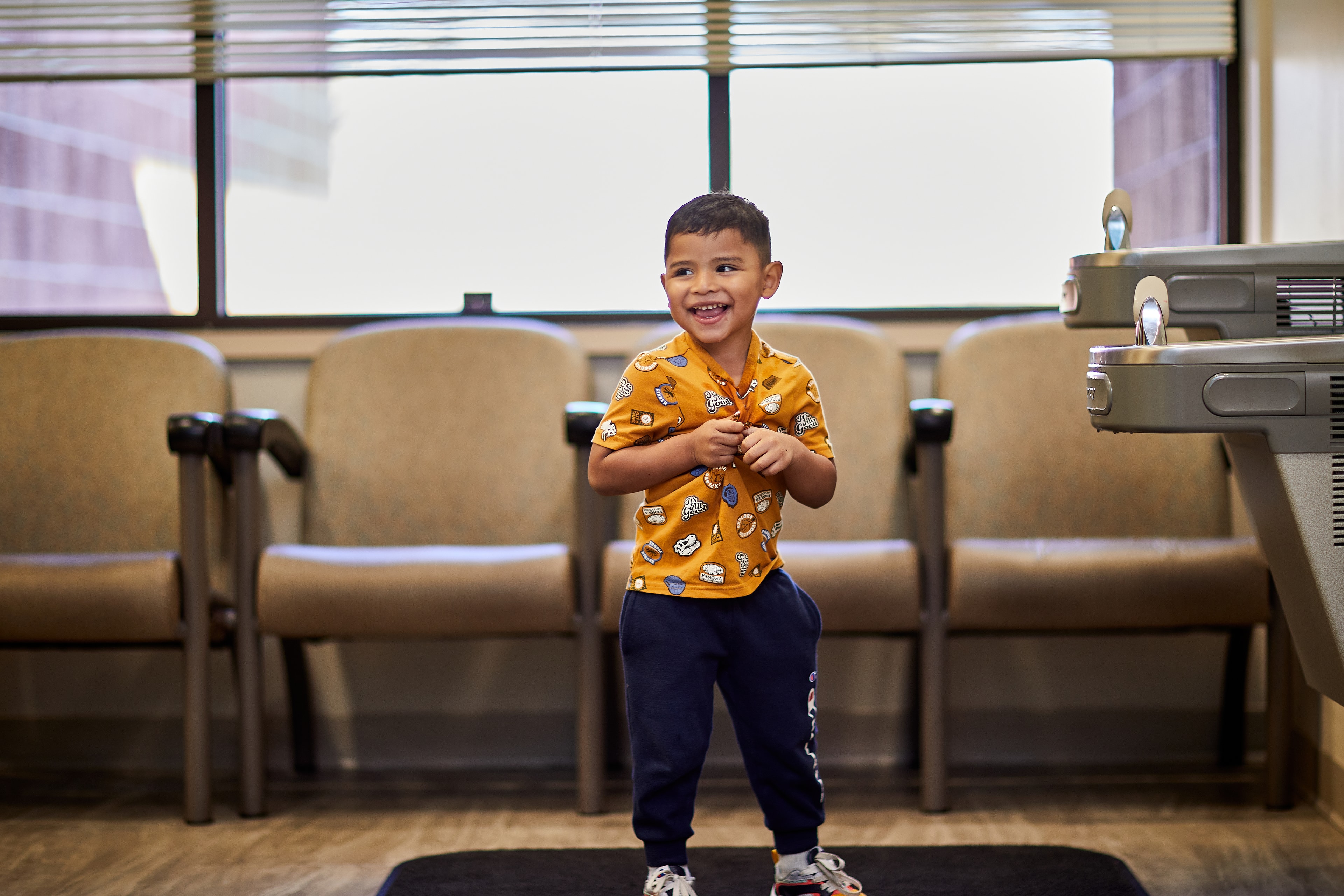 Young boy smiling in office waiting room