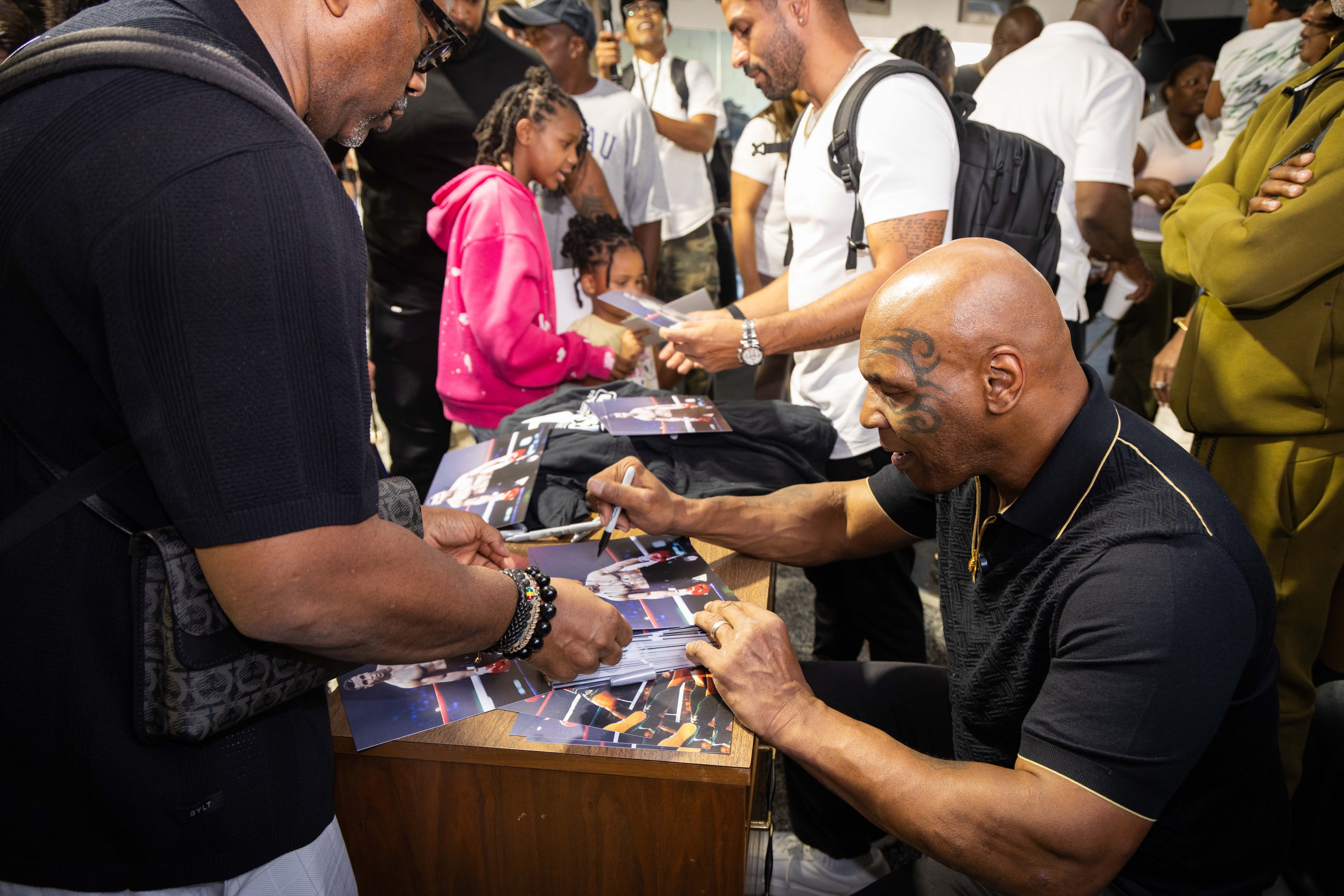 Celebrity signing autographs at fan meet event
