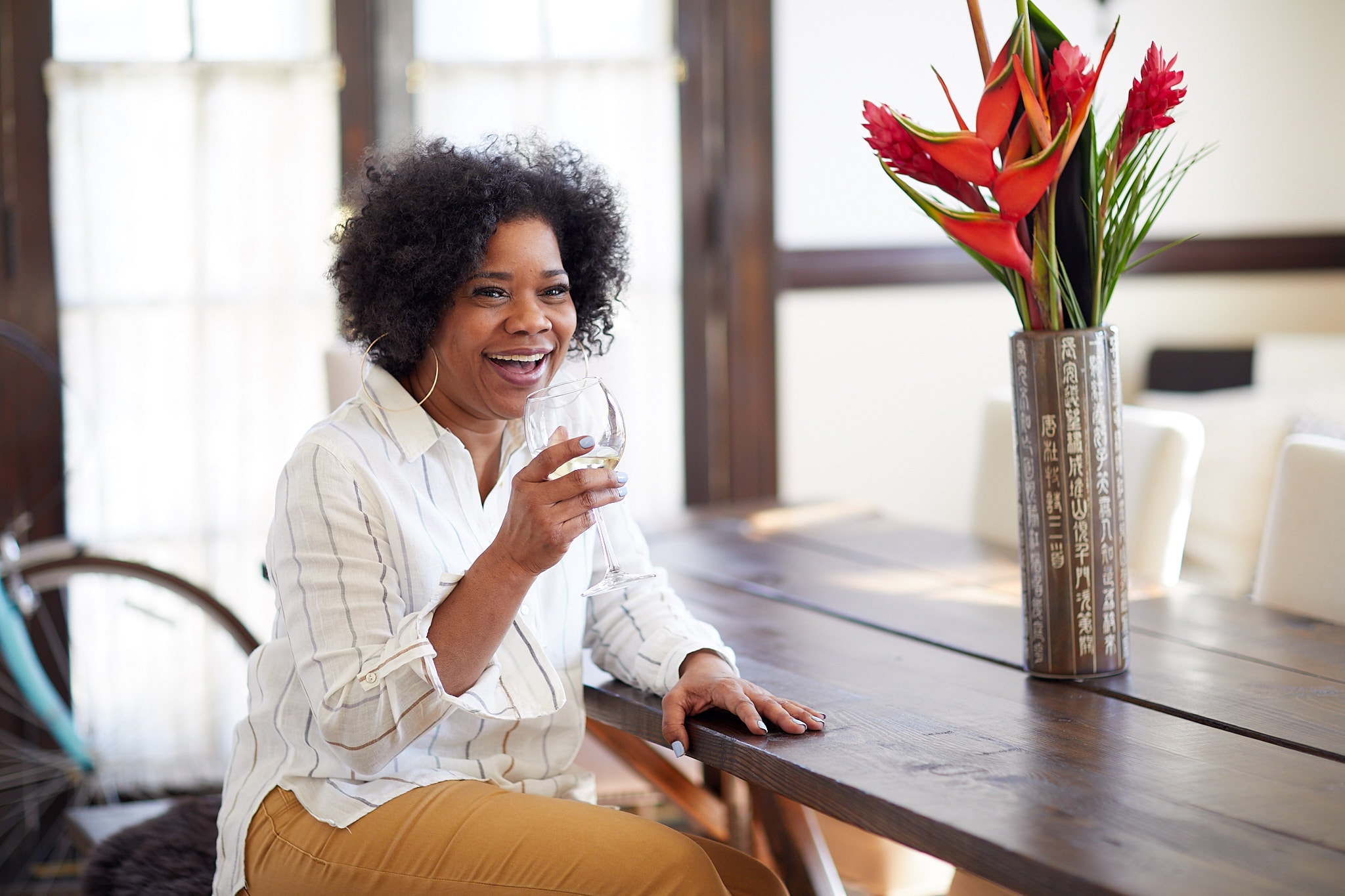 Woman holding wine glass red flowers