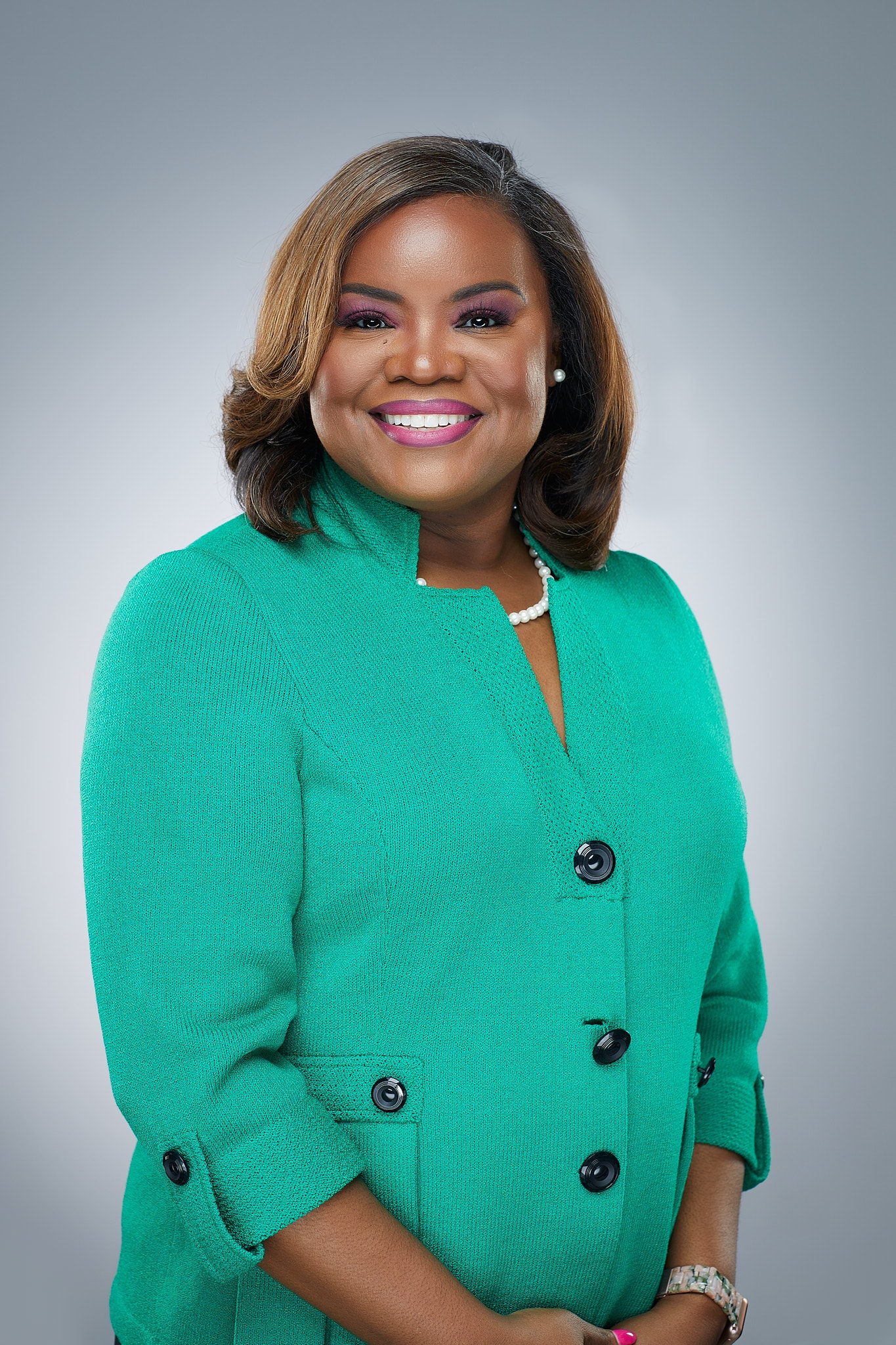 Woman wearing green blazer smiling portrait