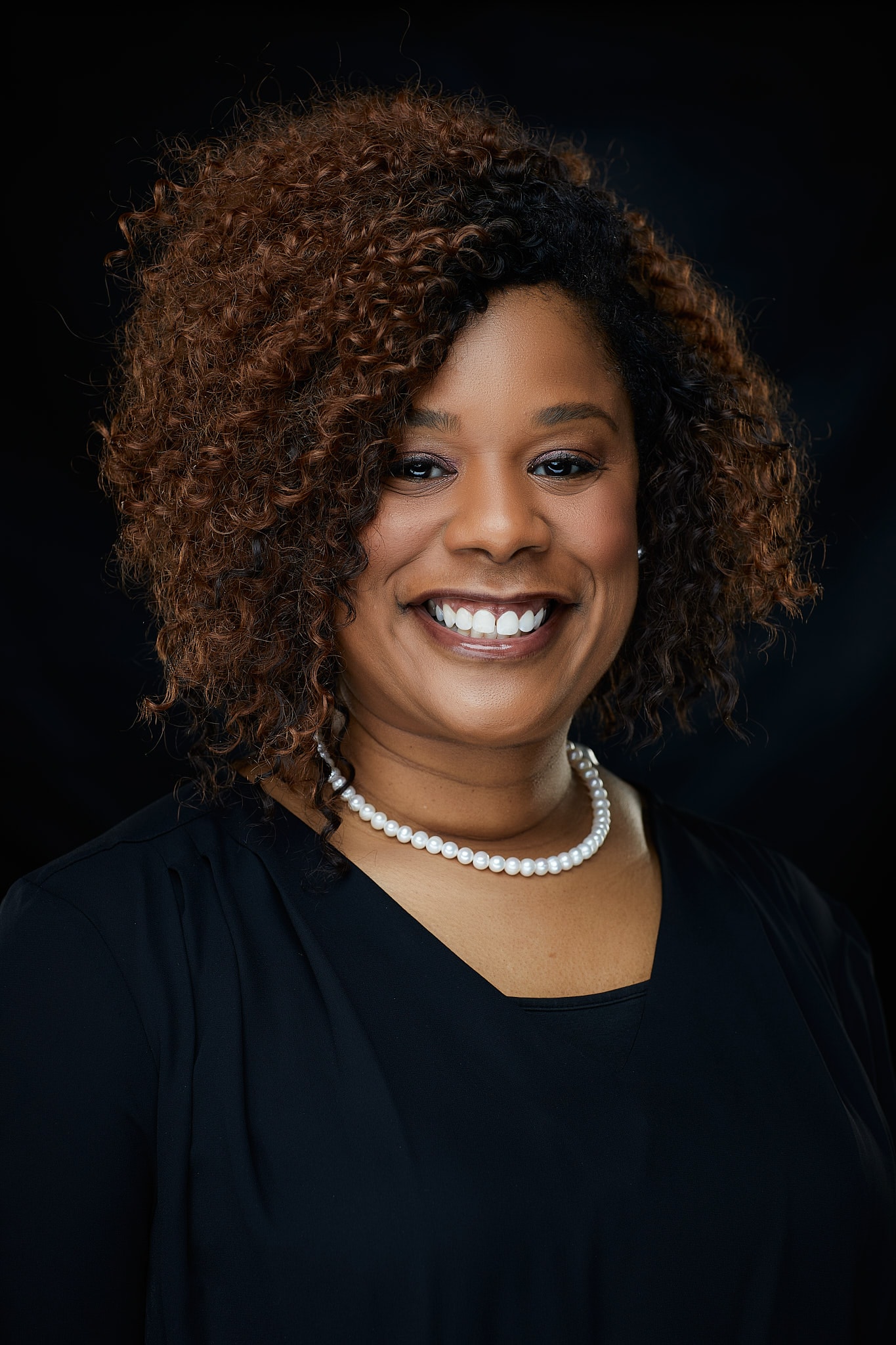 Woman with curly hair smiling portrait