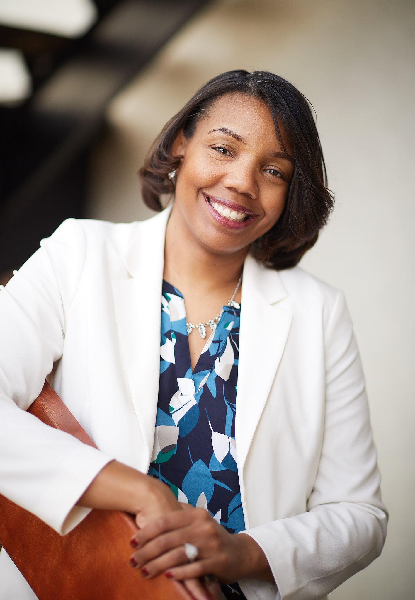 Professional woman smiling white blazer portrait