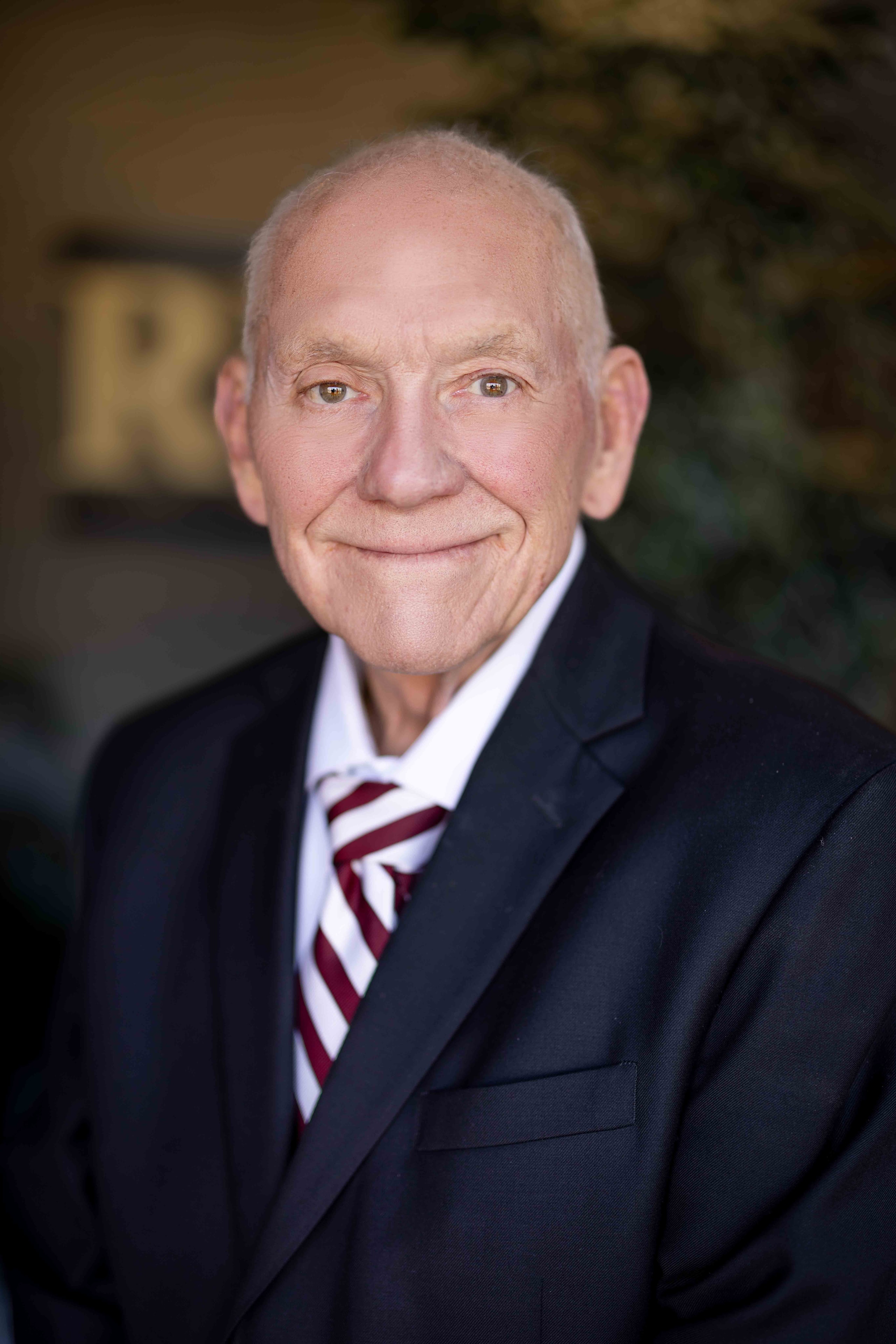 Senior man in navy suit striped tie