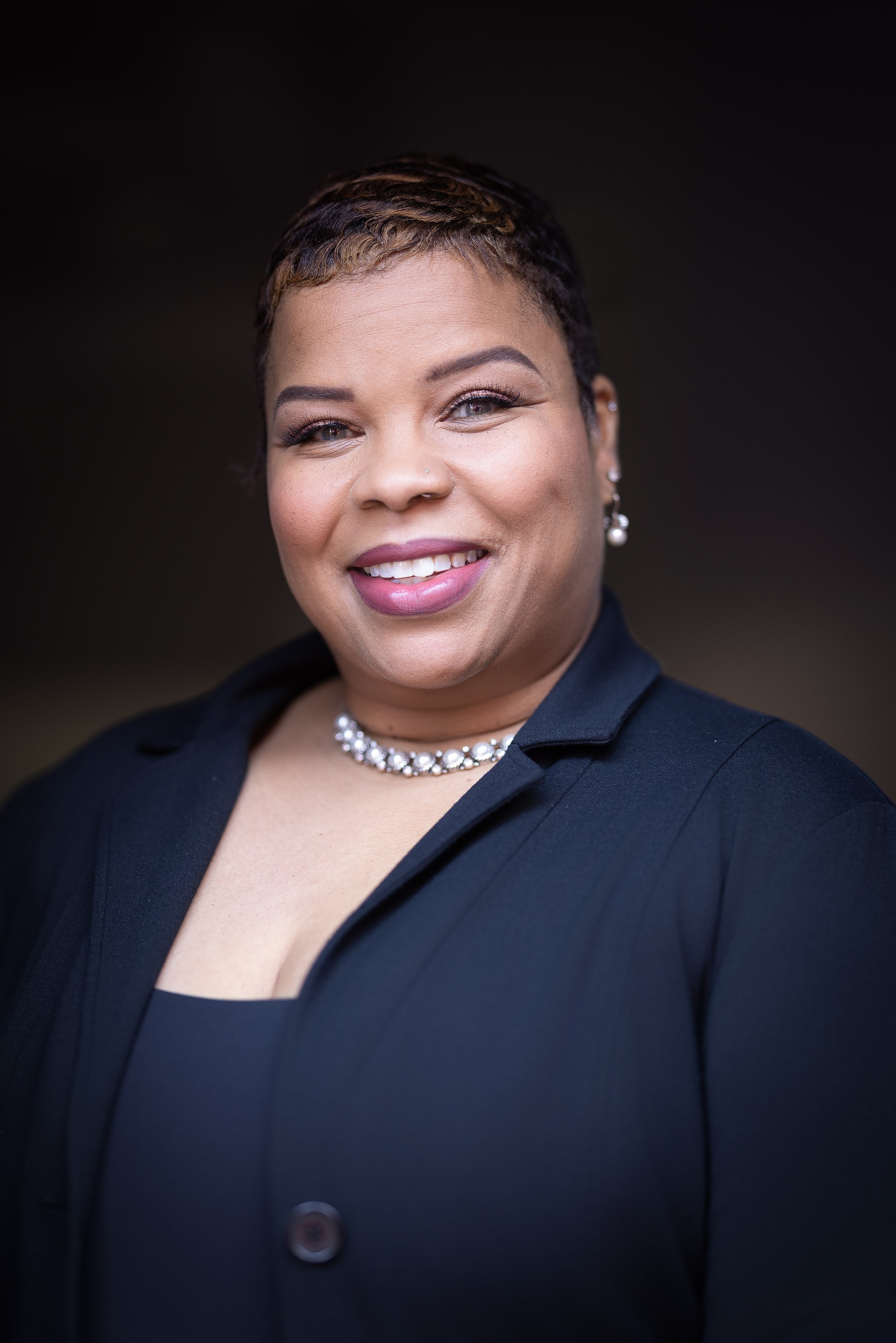 Woman in navy blazer smiling portrait