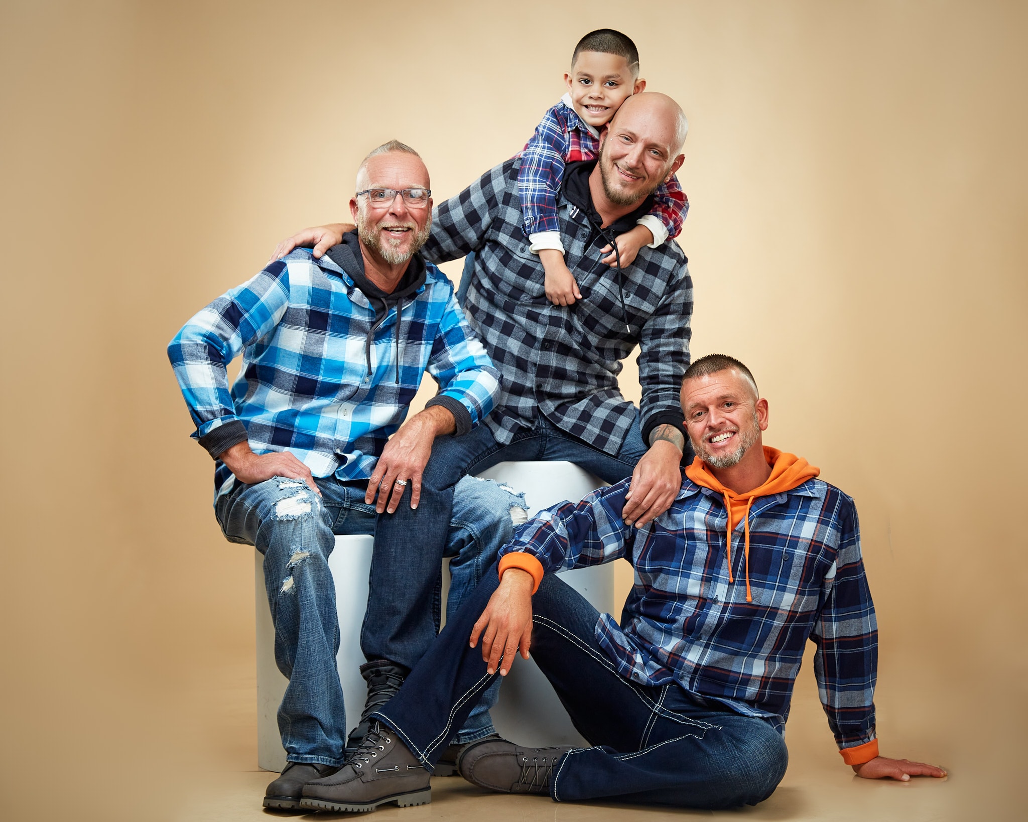 Three men and young boy posing together