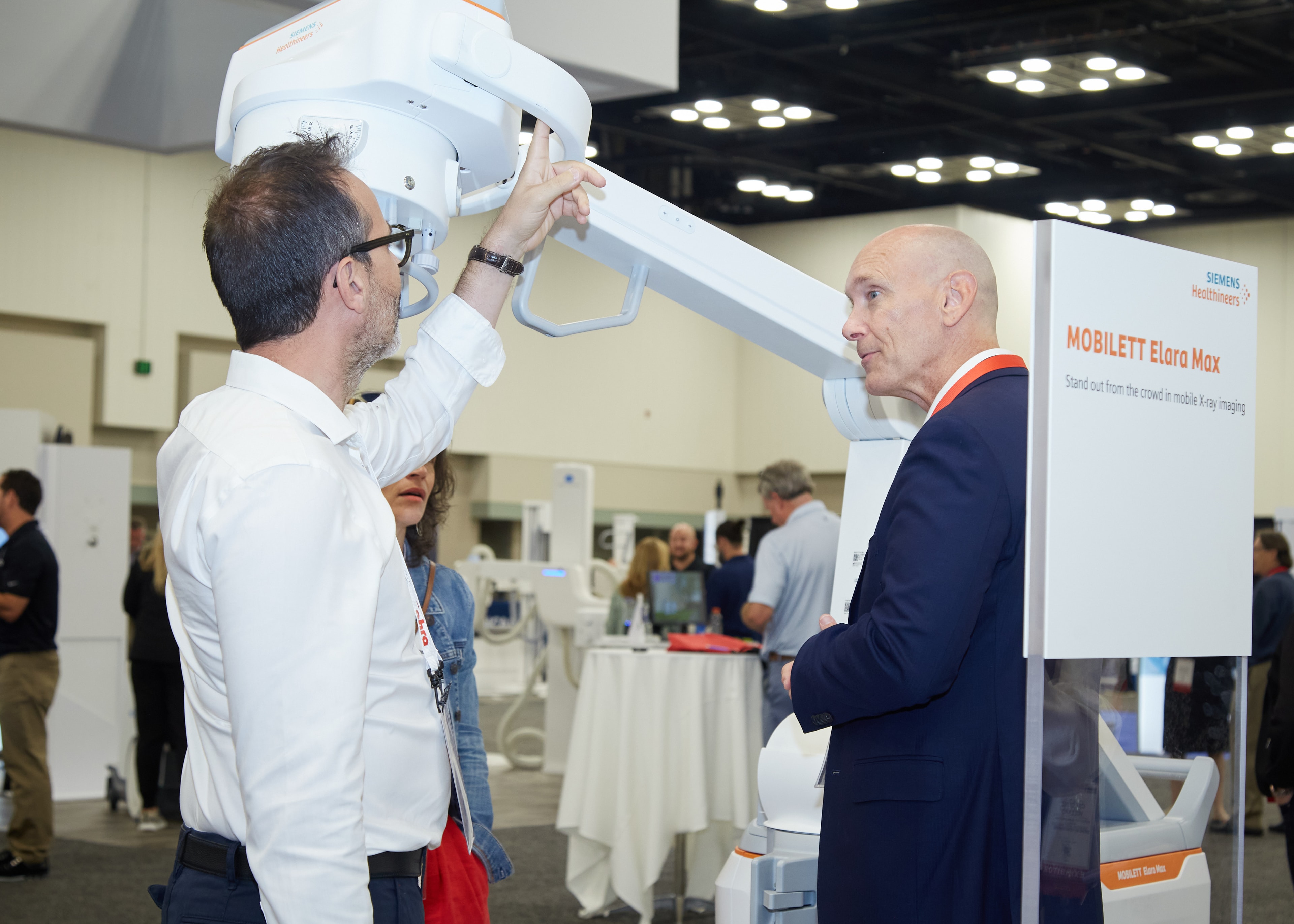 Men demonstrating medical imaging equipment